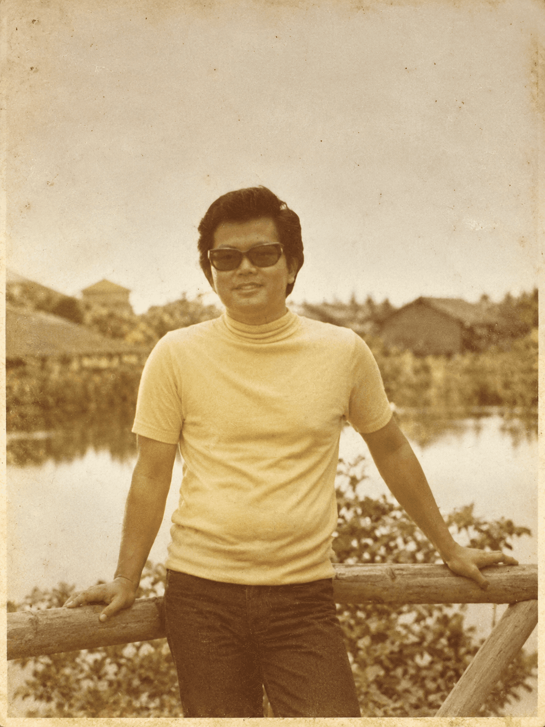 Robert in his youth, leaning on a railing by a lake